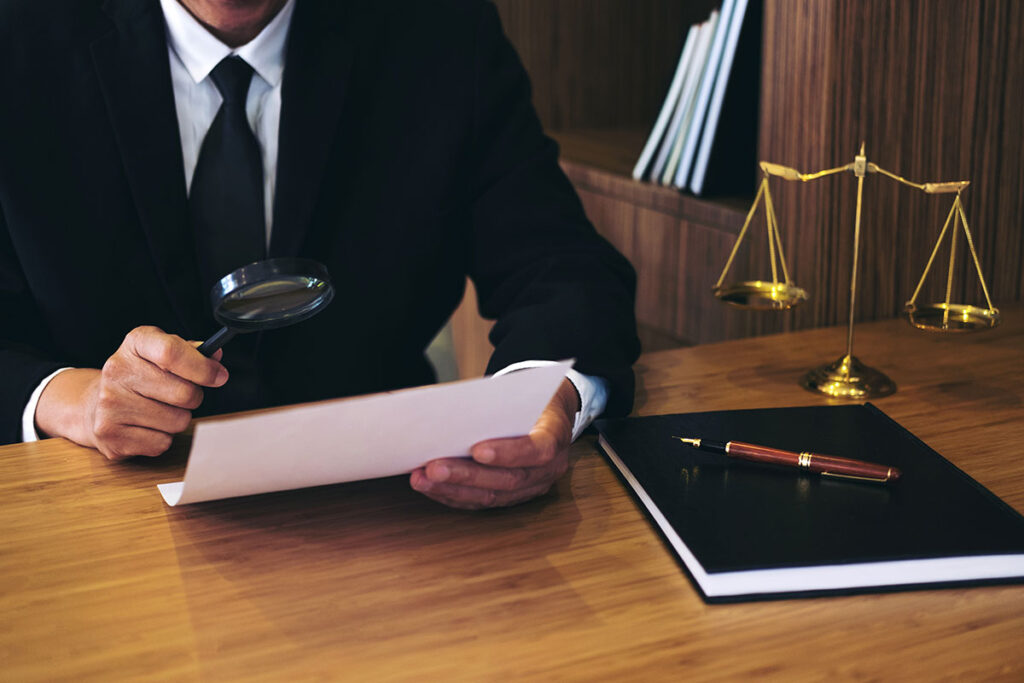 Lawyer looking at a document through a magnifying glass