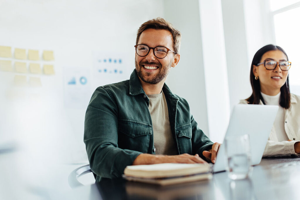 smiling man at a computer