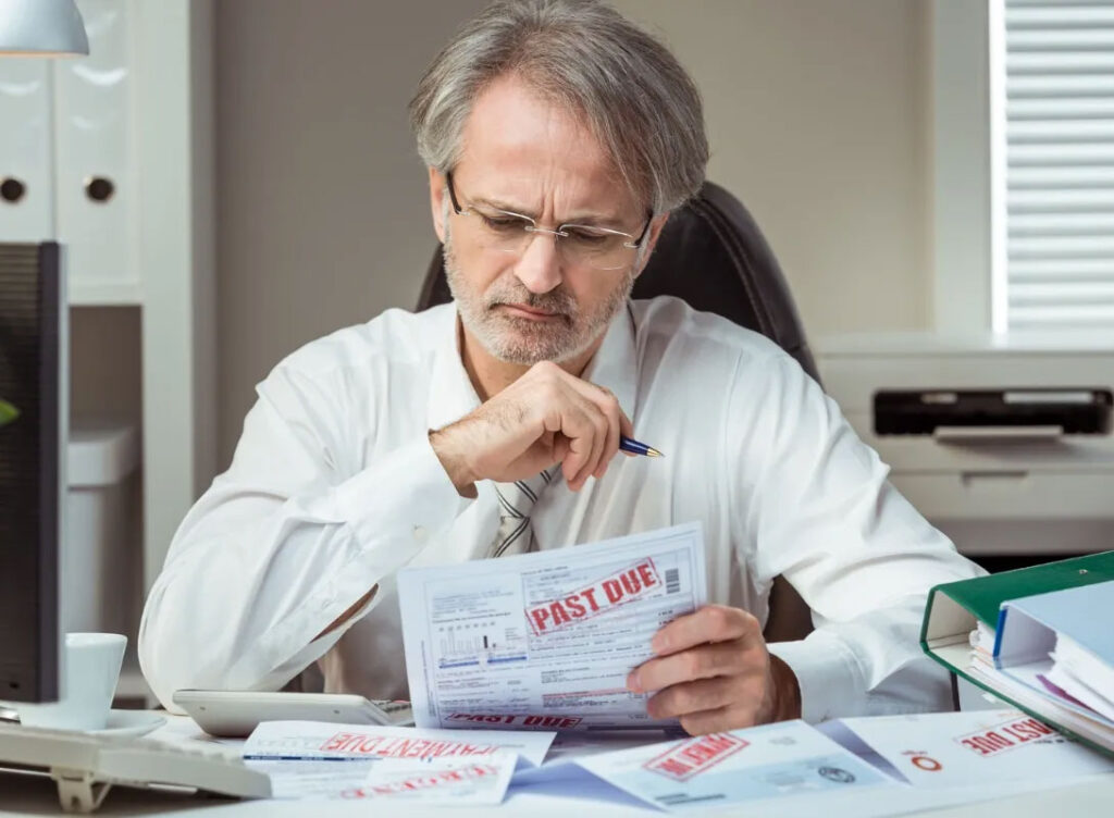 Man reviewing past due bills